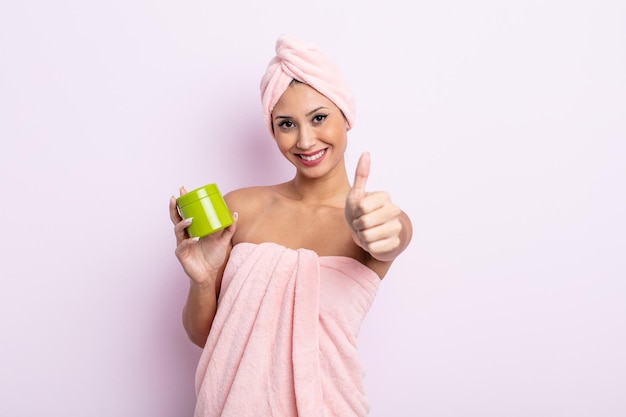 Asiatic pretty woman feeling proud,smiling positively with thumbs up. hair mask and care concept