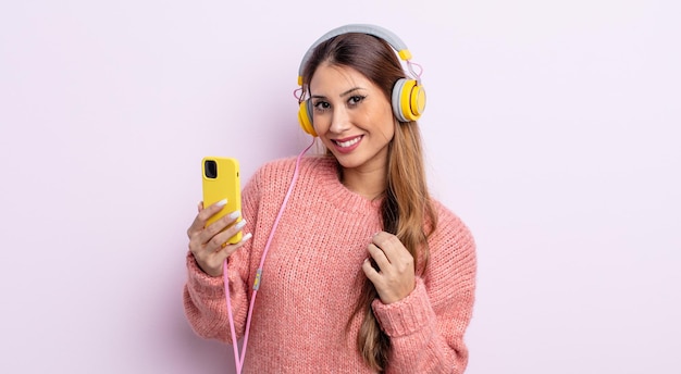 Asiatic pretty woman looking arrogant, successful, positive and proud. headphones and phone concept