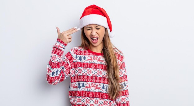 Asiatic pretty woman looking unhappy and stressed, suicide gesture making gun sign. christmas concept