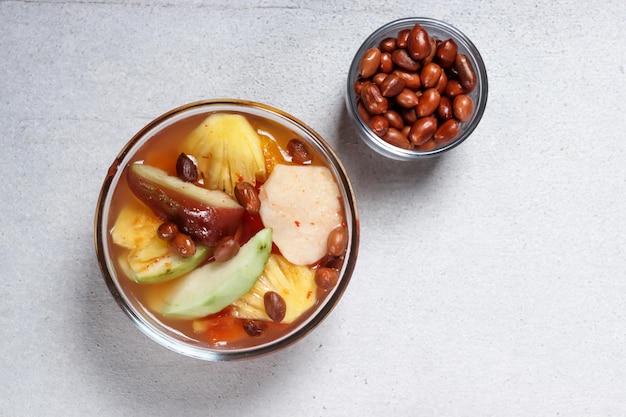 Asinan Buah Bogor is fruit pickle made from sliced fresh fruits on sweet, sour and spicy red soup.