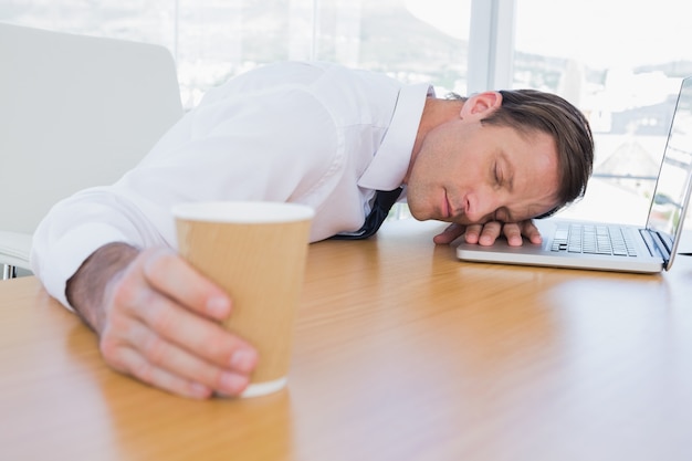 Asleep businessman on his laptop