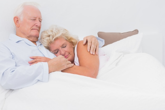 Asleep couple lying on the bed