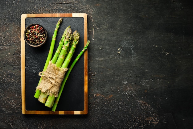 Asparagus on a brown background Green asparagus Top view Free space for your text