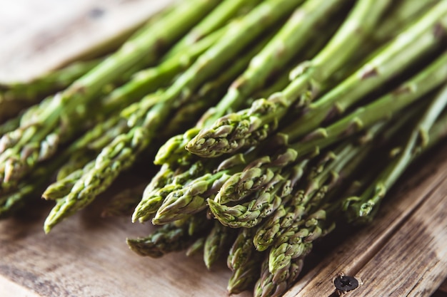 Asparagus on a cutting board. Healthy food, health on a concrete background.