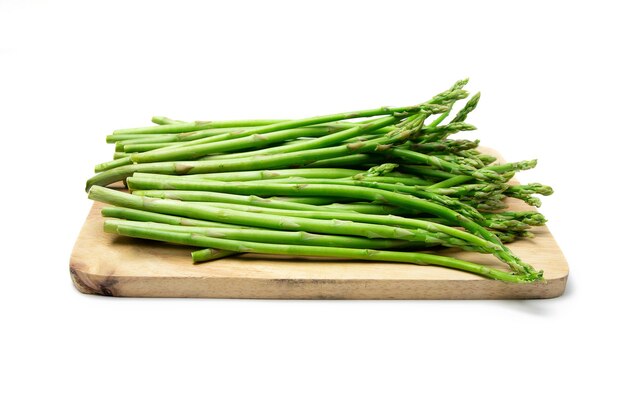 Asparagus on a cutting board, side view, white background