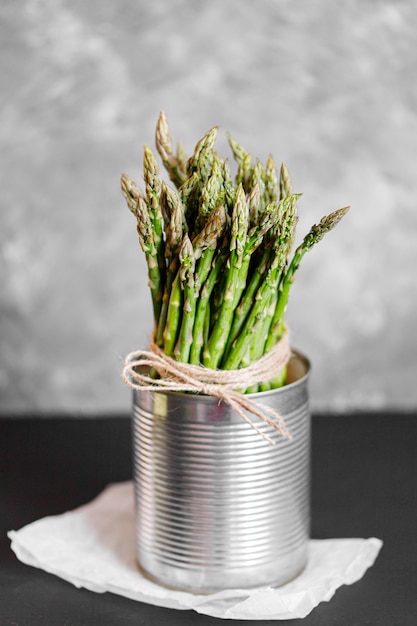 Asparagus. Fresh green asparagus on grey rustic background. Top view copy space. Bunches of green asparagus