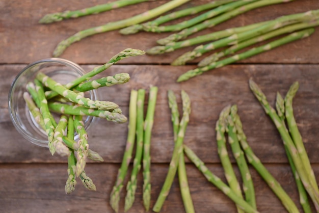 Asparagus in glass jar on wooden table