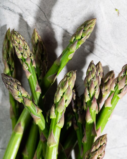 Asparagus on marble background. hard light food photography. Healthy eating concept. Vegetarian food.