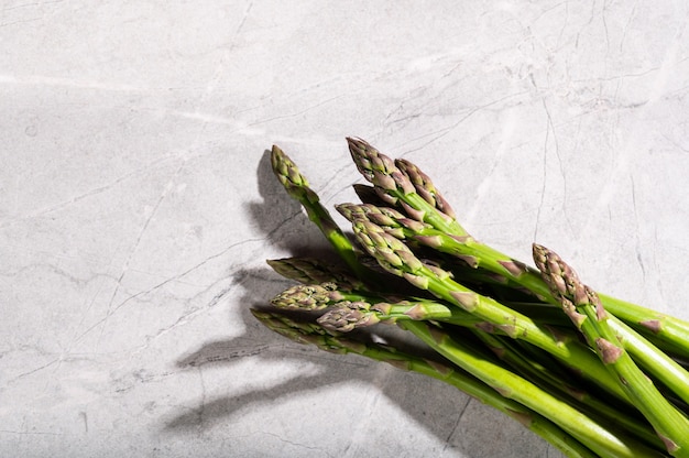 Asparagus on marble background. hard light food photography. Healthy eating concept.
