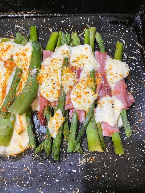 asparagus with cheese and ham au gratin in the oven