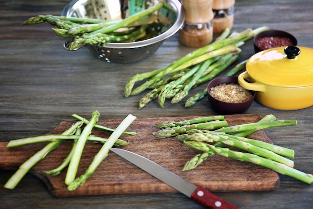 Asparagus with knife on cutting board