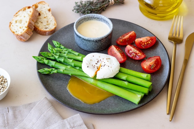 Asparagus with poached egg tomatoes and hollandaise sause Healthy eating Vegetarian food