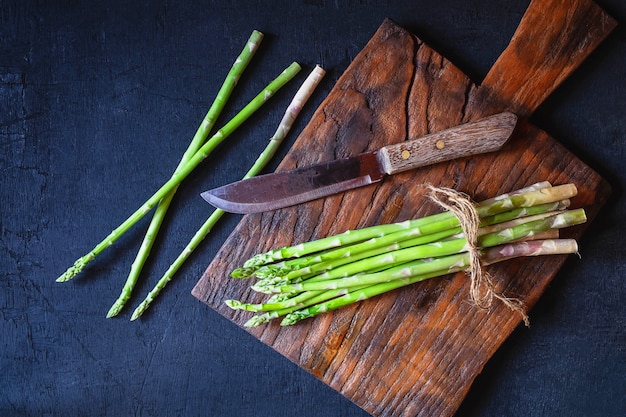 Asparagus on a wooden cutting board