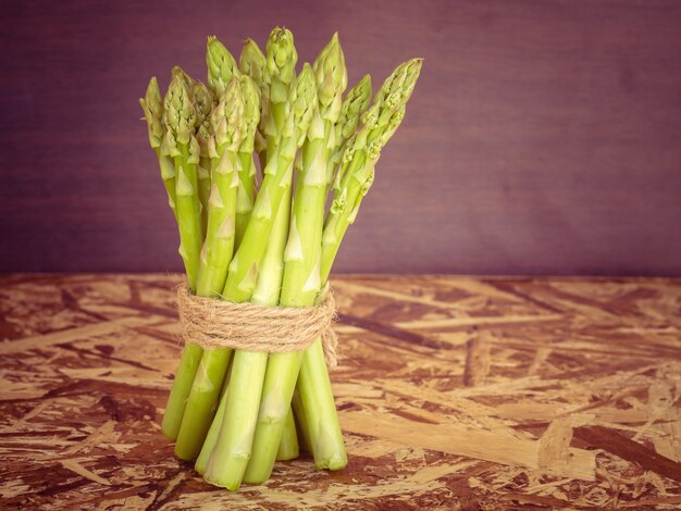 Asparagus on wooden table with filter effect retro vintage style