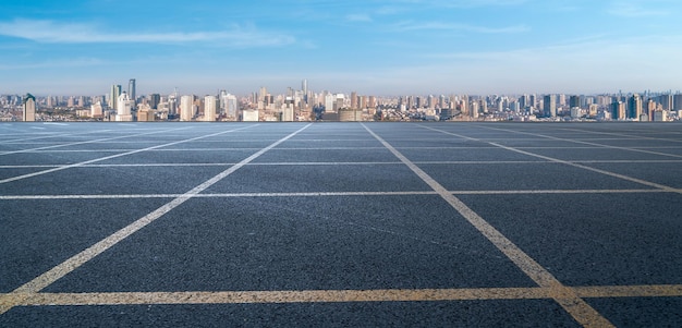 Asphalt pavement and urban building skyline