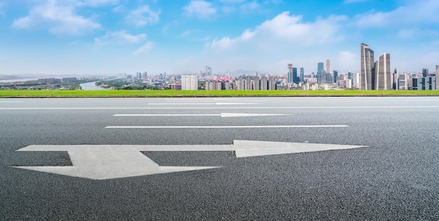 Asphalt pavement and urban building skyline