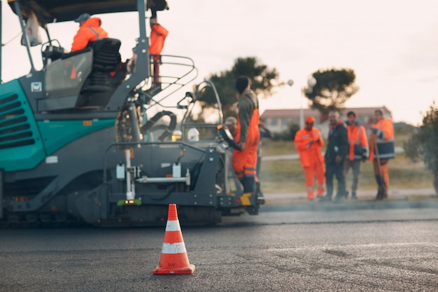 Photo asphalt paving. paver machine and road roller. new road construction.