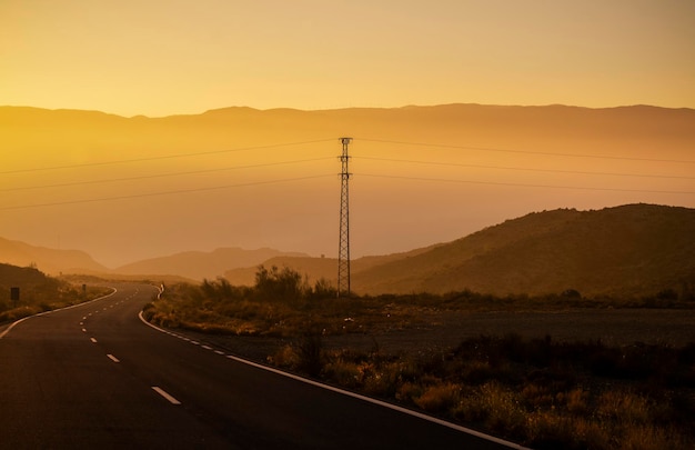 Asphalt road on countryside during sunset almeria spain