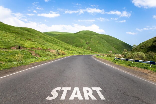 Asphalt road and the inscription start in the countryside