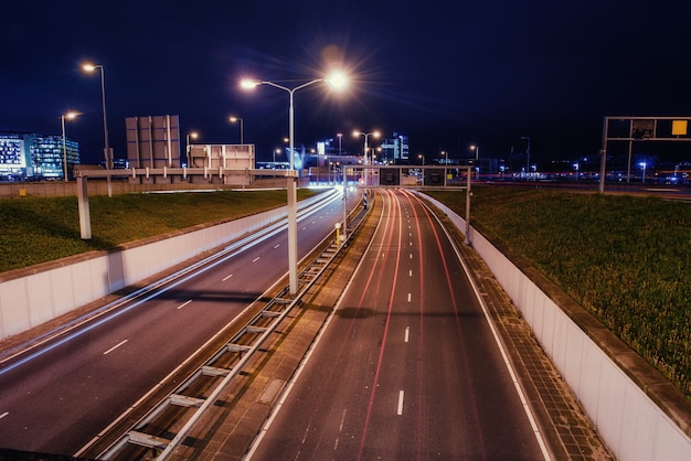 Asphalt road is lit at night.