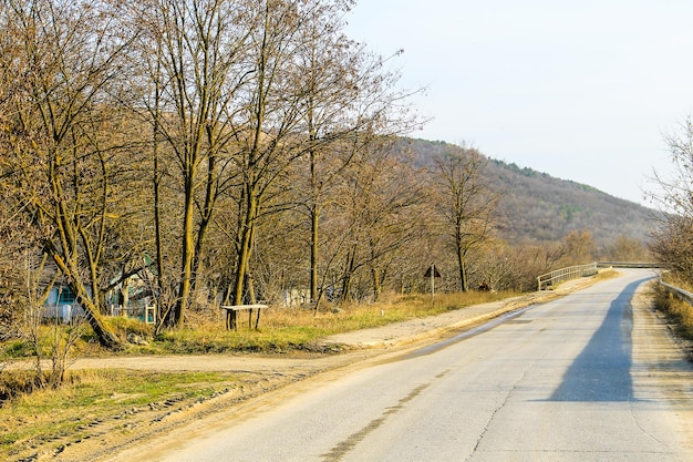 Asphalt road leading into the mountains on spring