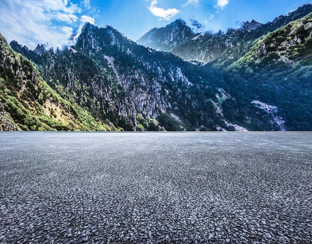 Asphalt road and mountain nature landscape under the blue sky in summer