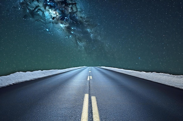 Asphalt road through the night sky with stars and milky way