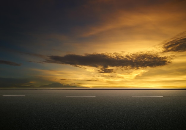 Asphalt road with dramatic sunrise sky Horizontal format