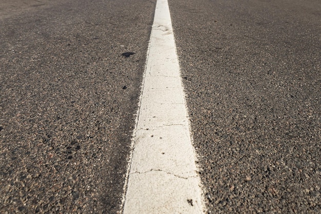 Asphalt road with single solid white line road marking