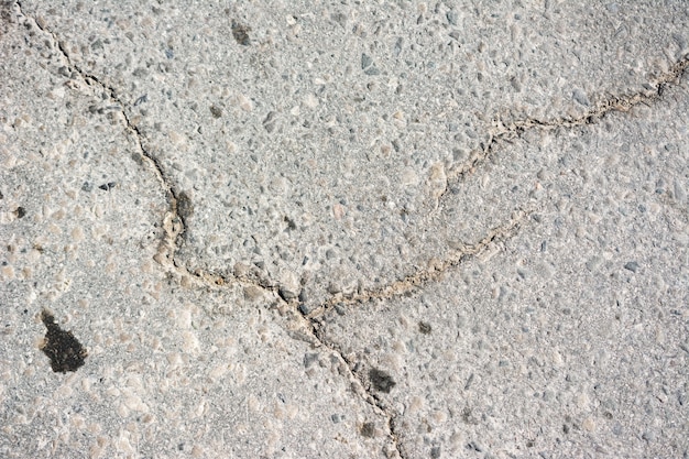 Asphalt texture. Cracked asphalt road surface texture. Crack asphalt background