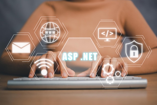 aspnet development programming language concept person hand typing on keyboard computer with aspnet icon on virtual screen
