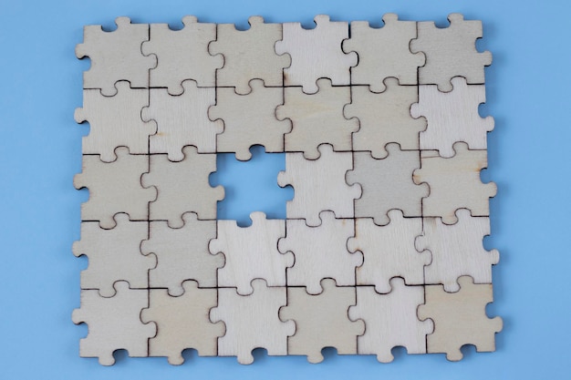 assembled blank wooden puzzles with emphasis on the missing puzzle