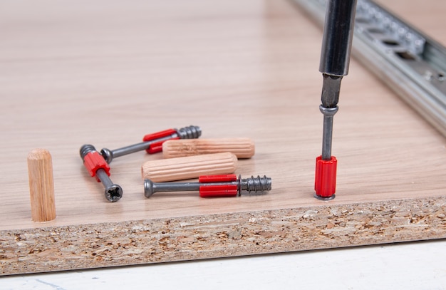 Photo assembling furniture using a screwdriver