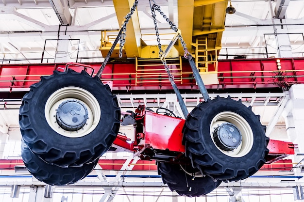 Photo assembly workshop at big industrial plant tractor assembling