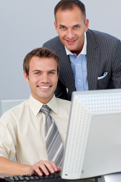 Assertive business partners working together at a computer 