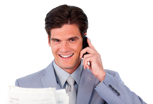 Assertive businessman on phone holding a newspaper 