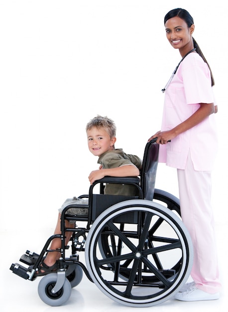 Assertive female doctor carrying a patient in a wheelchair 