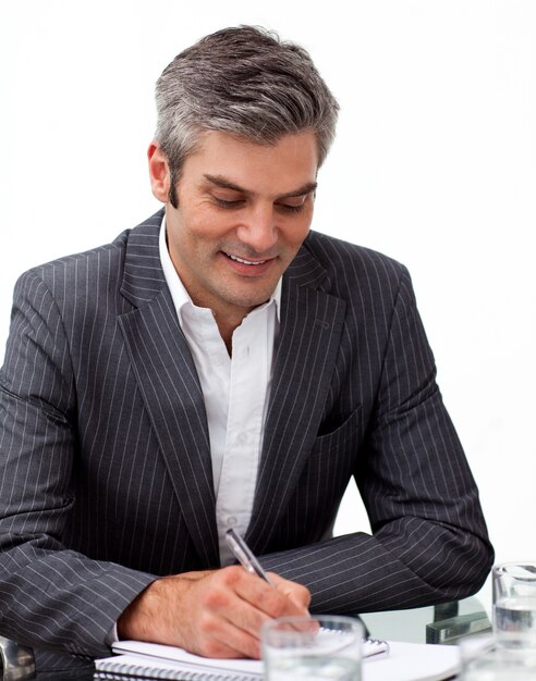 Assertive mature businessman studying a document 