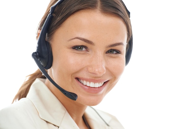 Assistance is her speciality A closeup studio shot of a smiling female operator wearing a headset isolated on a white background