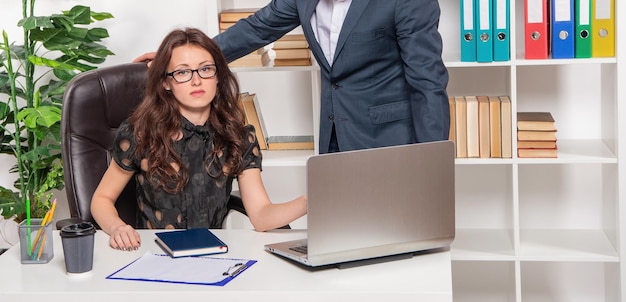 Assistant manager Serious manager at work desk Secretary and boss cropped view in office