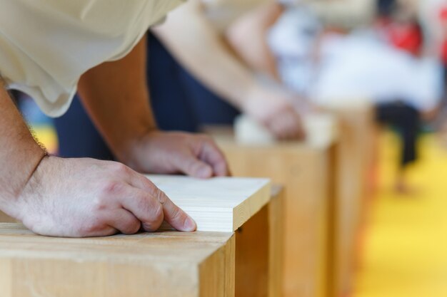 Photo assistant stacks the wooden boards