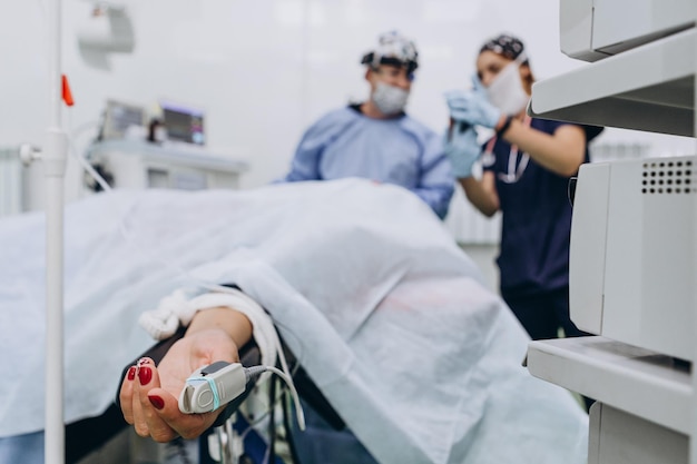 assisting during surgery shows something on the surgeon's phone during surgery selective focus