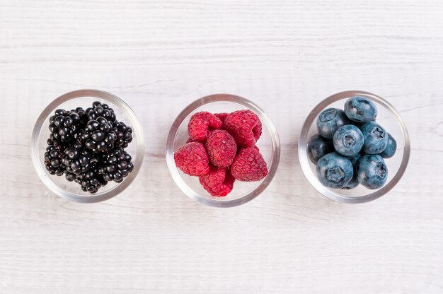 Assorted berries in glass bowls