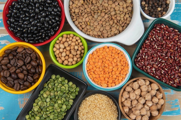 Assorted bowls with raw grain and seeds top view