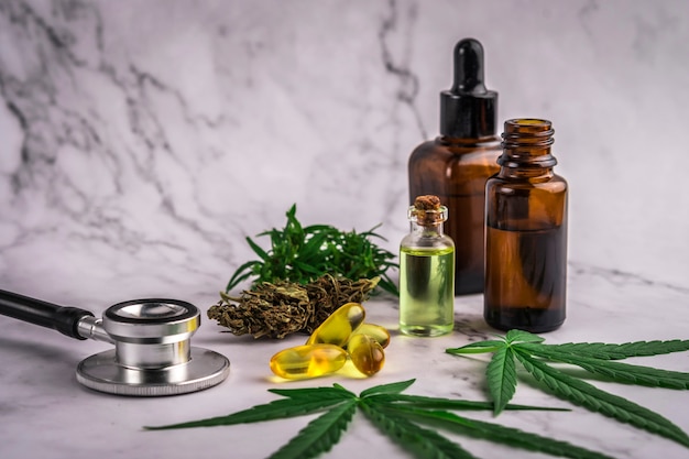 Assorted cannabis products, pills and cbd oil over medical prescription sheet 