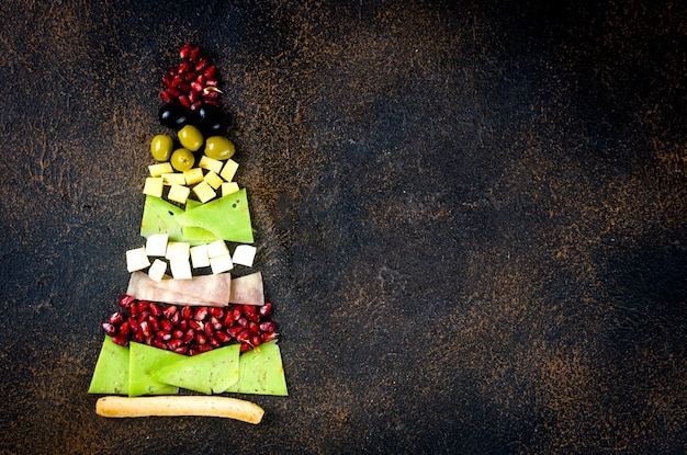 Assorted cheese pieces laid out in the form of a Christmas tree