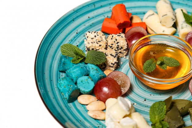 Assorted cheese on plate with a white