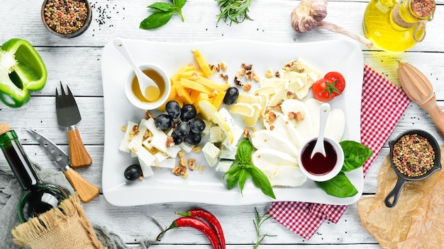 Assorted cheese with grapes and honey Restaurant dishes Top view Free space for your text