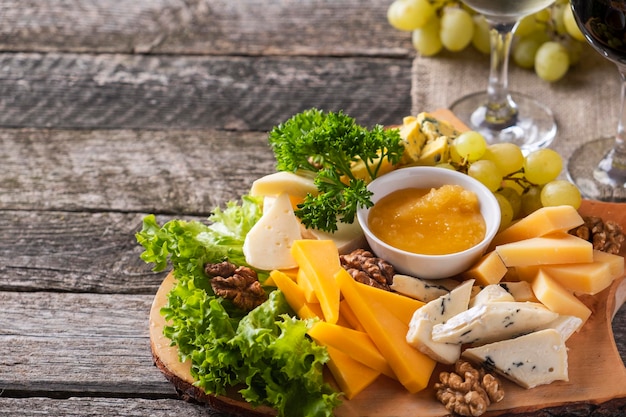 Assorted cheeses Tasty cheese plate on a wooden board Copyspace