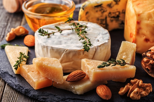 Assorted cheeses on a wooden board